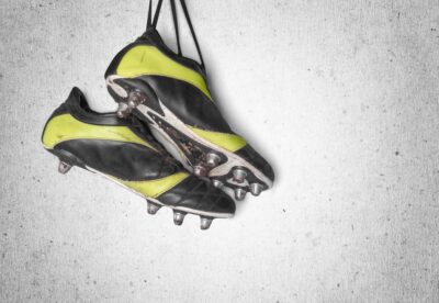 stock-photo of hanging football boots with cleats isolated