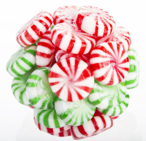 Hard red, green and white candy mints stuck in a ball